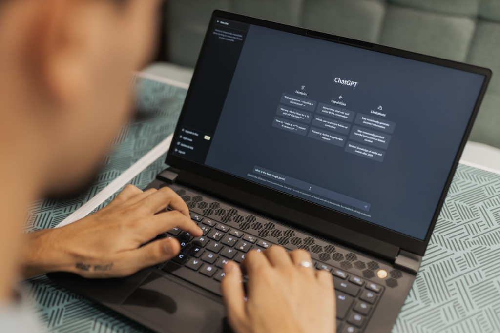 Person typing on laptop using ChatGPT