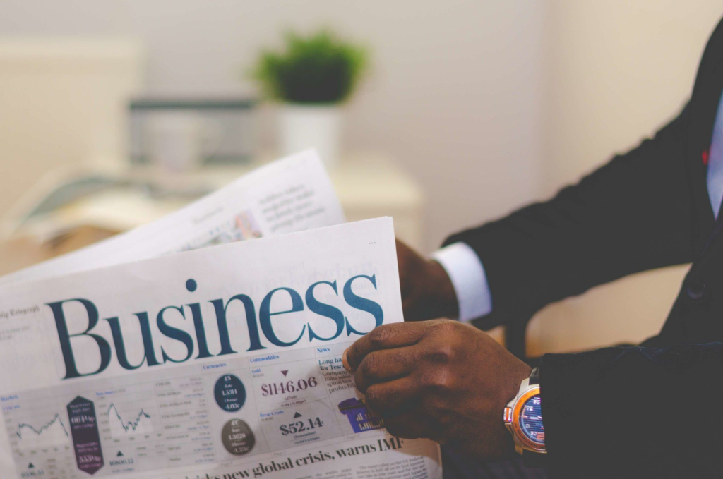 Man reading business newspaper indoors